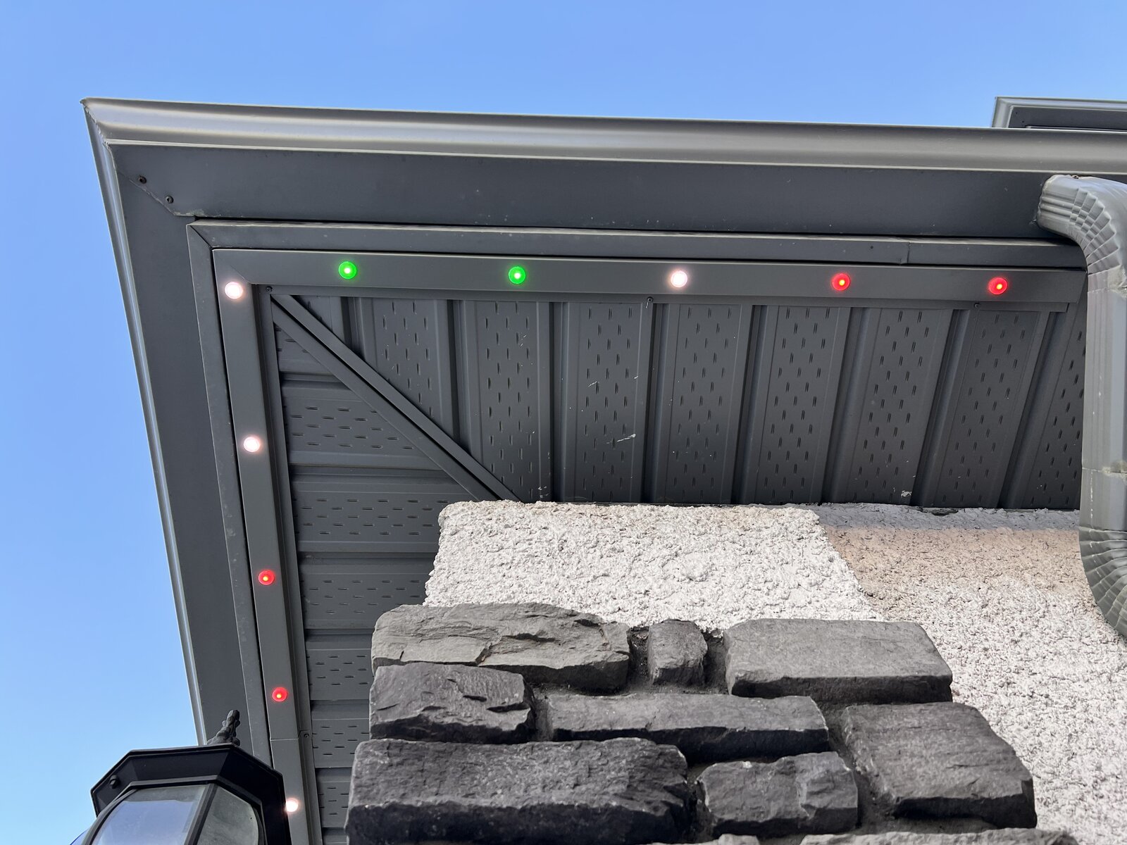Close-up of permanent LED soffit lighting track installed under the eaves of a Winnipeg home