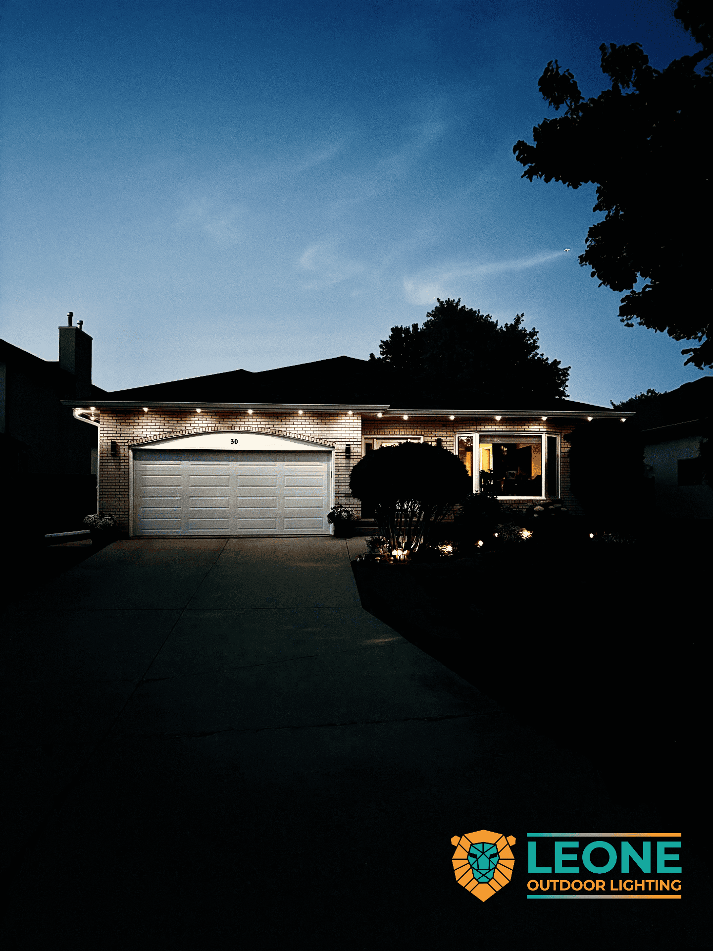 Warm white permanent lighting and landscape lighting on Winnipeg ranch style home