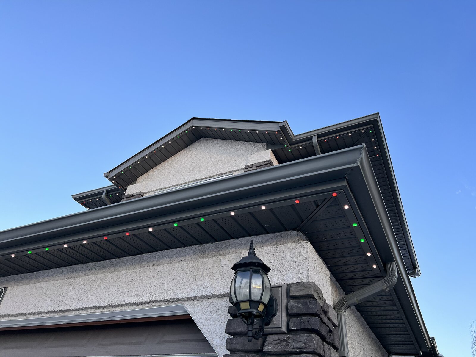 Colour-matched soffit lighting channel running along the roofline of a Winnipeg house