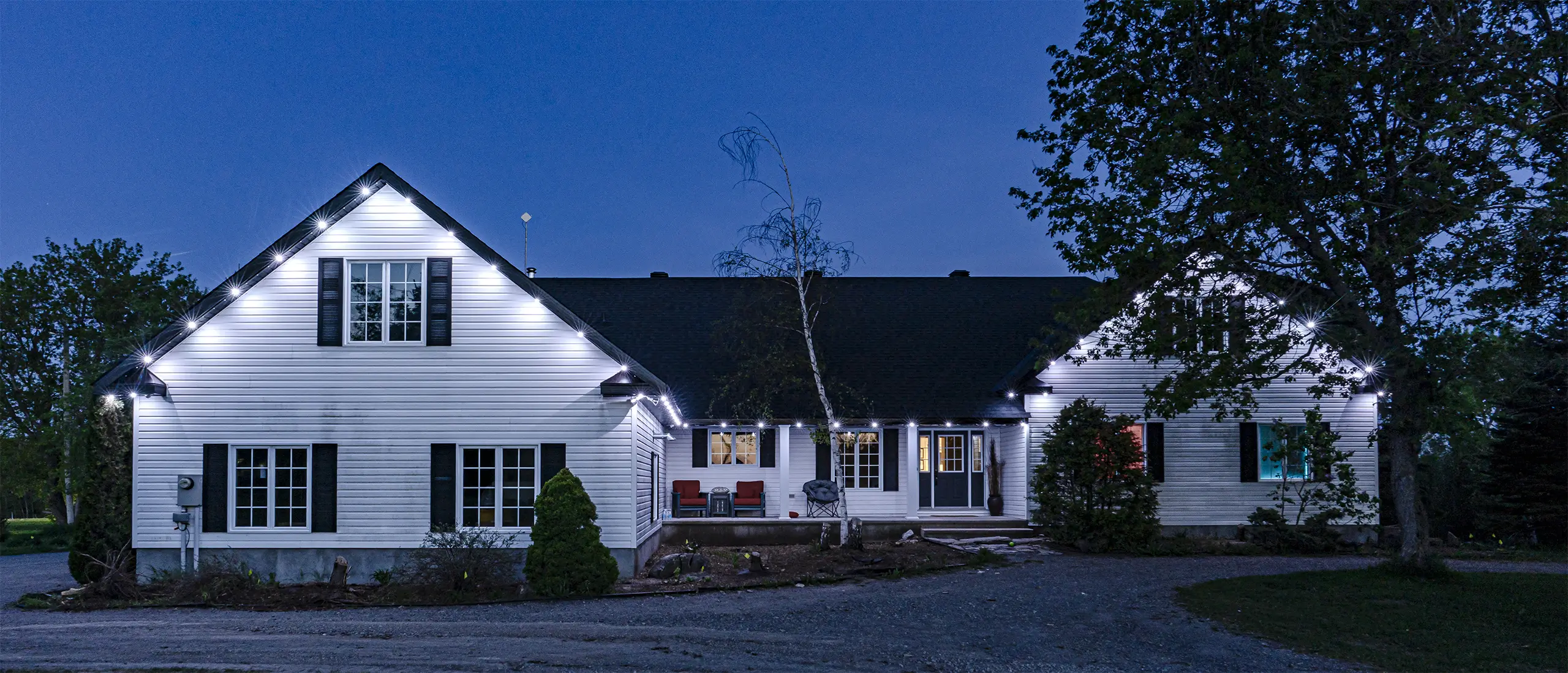 Celebright permanent LED lighting on white farmhouse