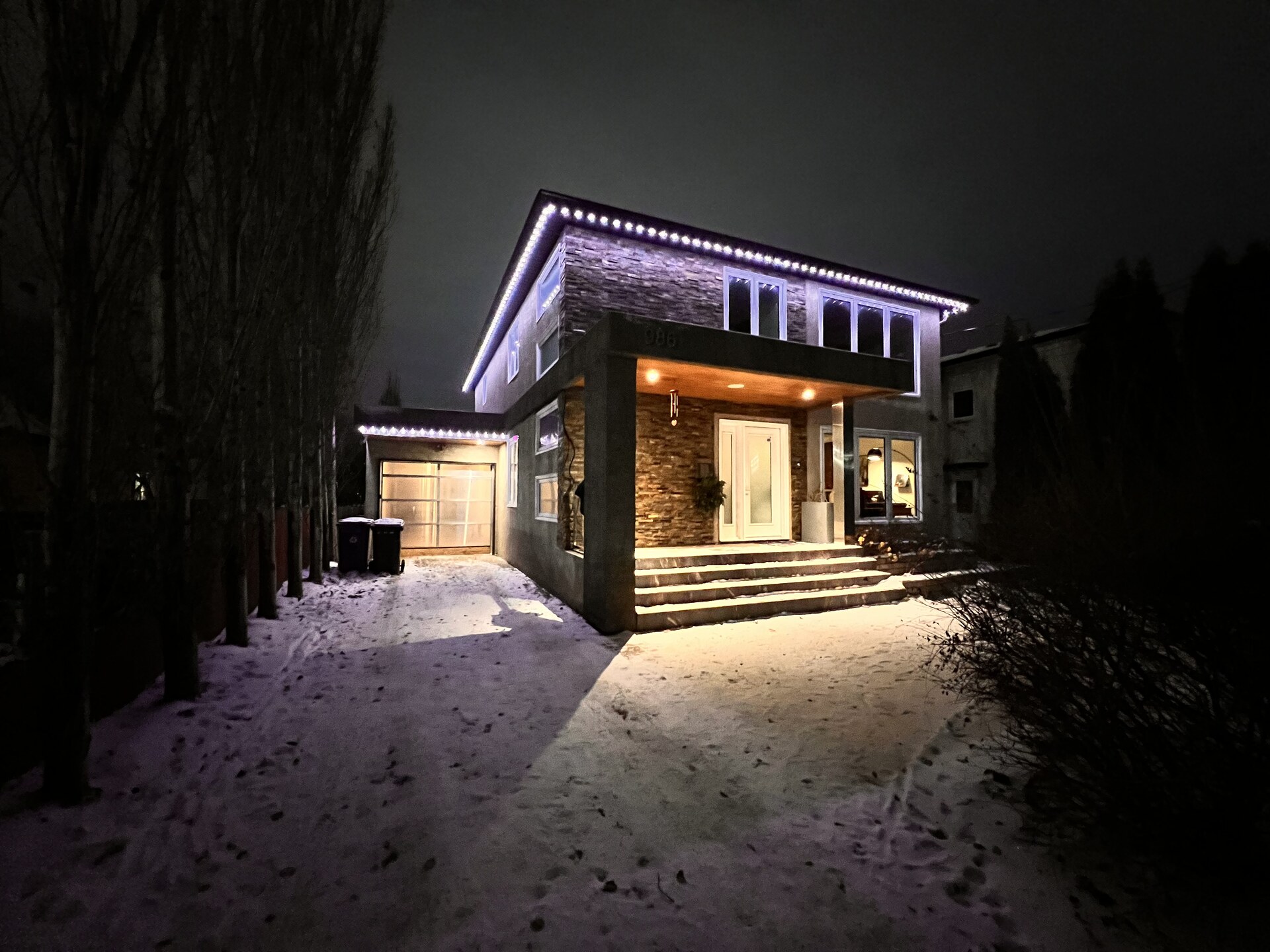 Cool white and purple permanent LED accent lighting on contemporary home