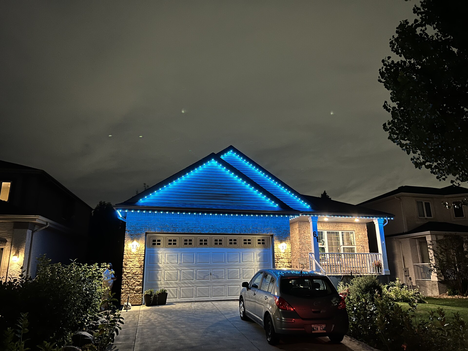 Bright blue permanent LED roofline lighting on family home